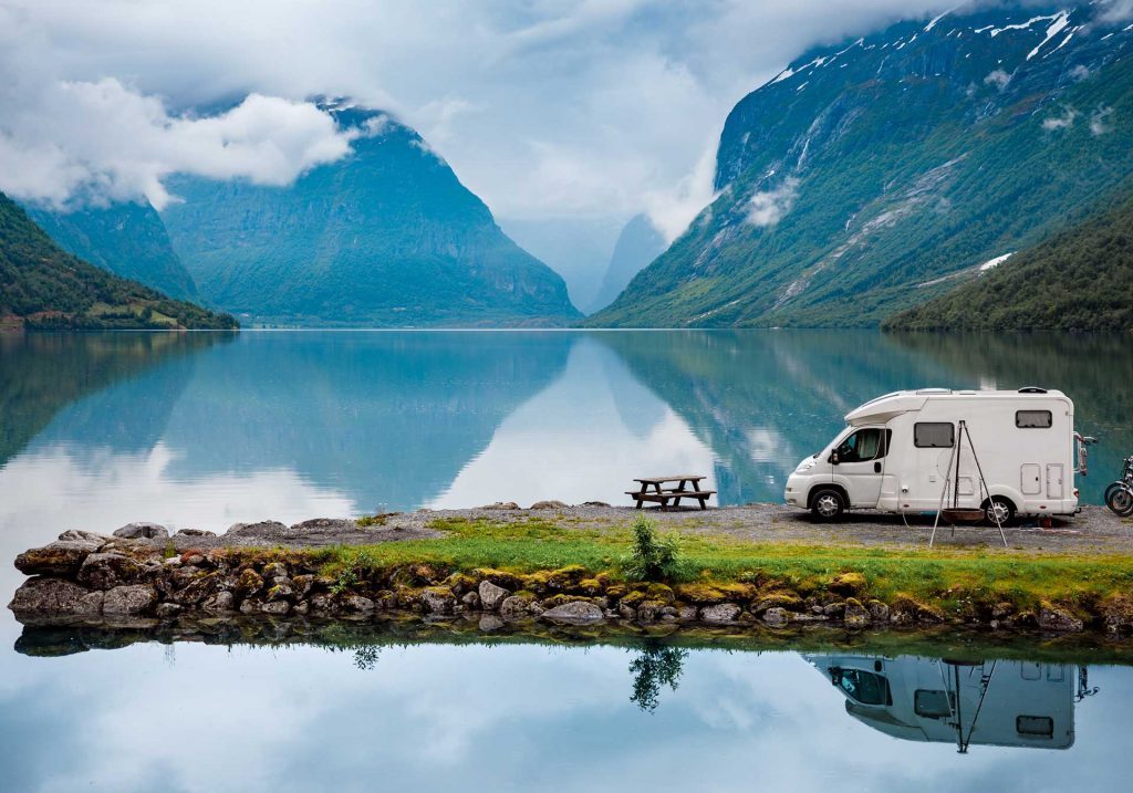 Personal caravan by a lake with mountains